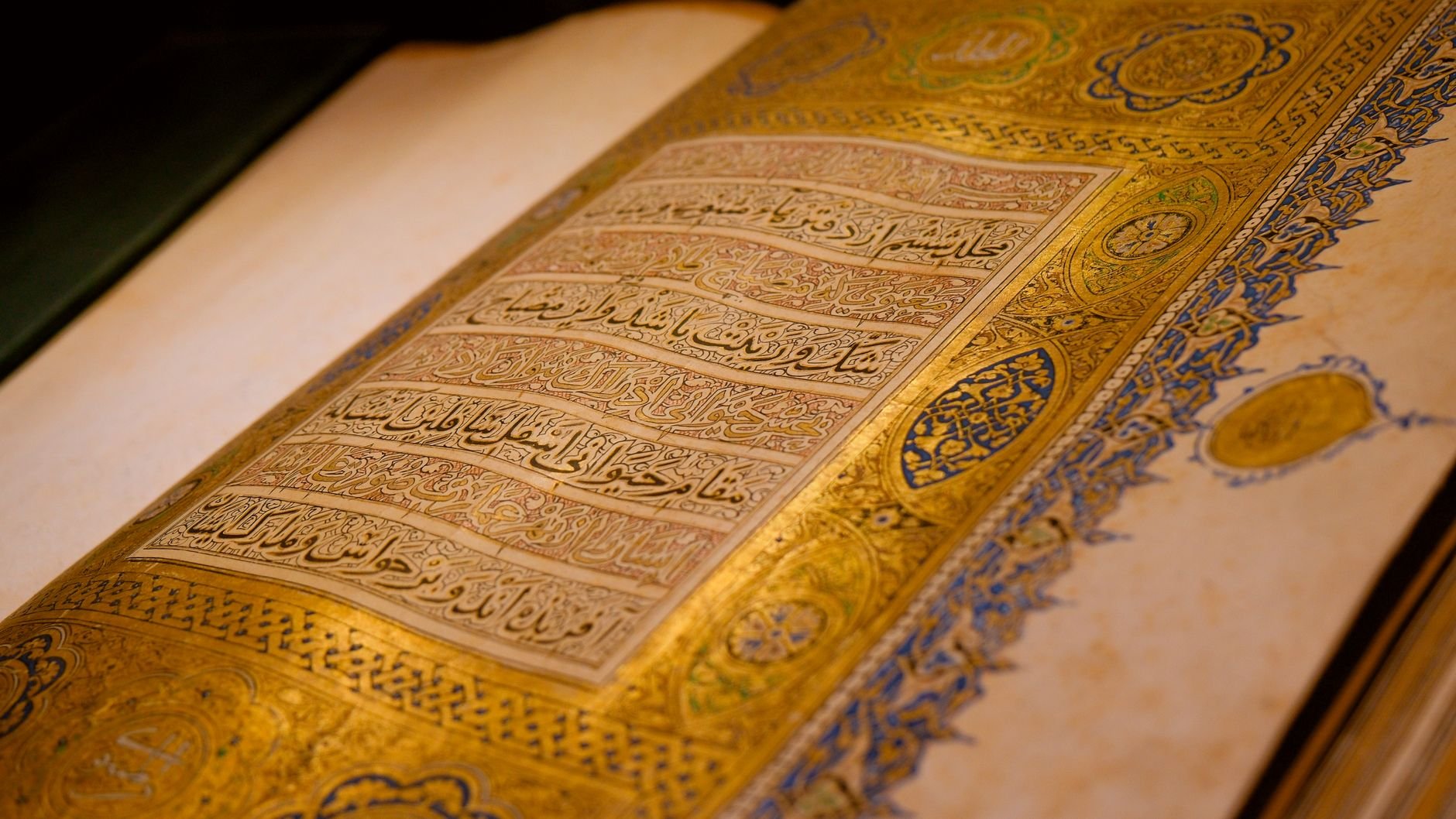 Close-up of a beautifully decorated ancient manuscript in Konya, showcasing intricate gold detailing.