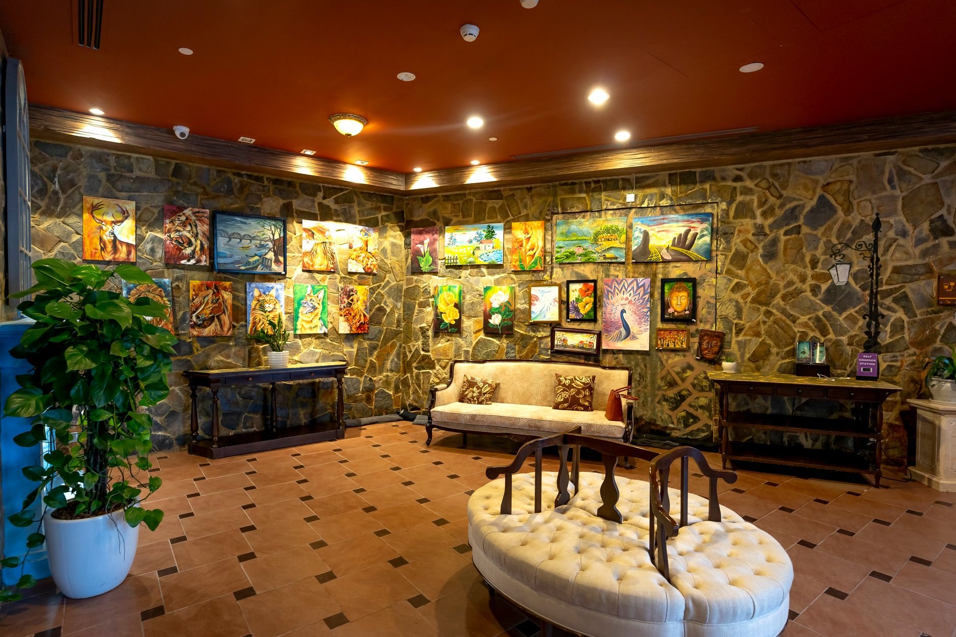 Elegant gallery interior featuring artistic paintings and luxury decor.